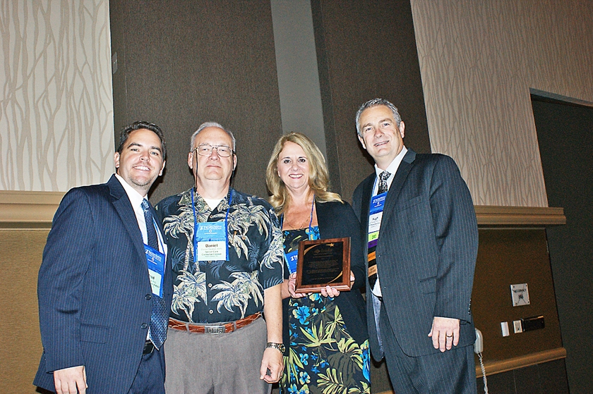 DSC03790.JPG - FMDA President Dr. Hugh Thomas (right) presents a plaque to the Florida Chapter of the American Society of Consultants Pharmacists (from left), represented by their executive director, Brad Kile, past-president Daniel Seckler, and President Janet Dallman
