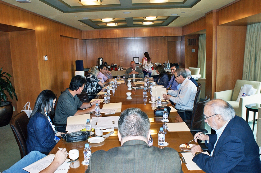 DSC03891.JPG - Chairman of the Board, Dr. Carl Suchar (seated at the far end of the table), conducts the post-conference wrap-up meeting with members of the CME/Education Committee.